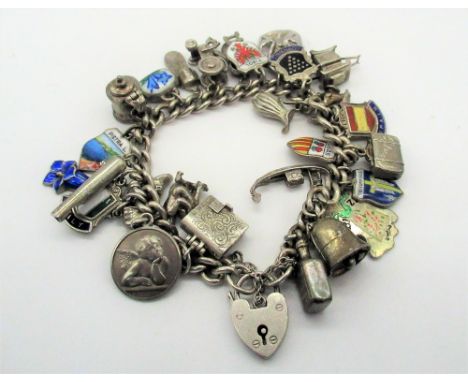 Hallmarked Sterling silver charm bracelet including enamel souvenir, bible, whistle, etc with heart padlock clasp and safety 