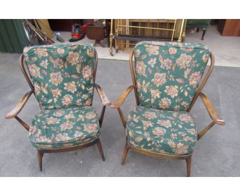 Pair of Ercol style dark wood open framed armchairs with stick backs and floral upholstered cushions (2) 