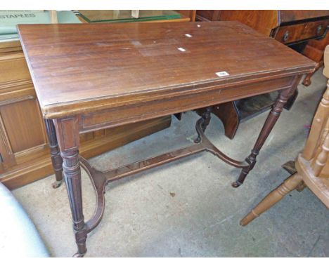 A 92cm Edwardian walnut fold-over card table with blue baise lined interior, set on turned supports with uniting stretcher