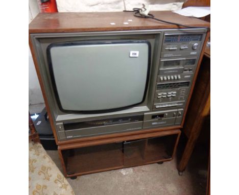 A vintage Fidelity AVS 2000 entertainment unit comprising TV, turntable, cassette deck, tuner and amplifier, set in wooden ca