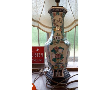 A large decorative ceramic hand painted Chinese lamp on plinth base