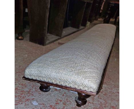 A 1.25m mahogany low footstool with machine oatmeal tapestry upholstered top, set on short turned feet