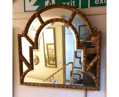 A vintage gilt framed wall mirror with break arch top, central bevelled plate and further beaded mirror plates to surround