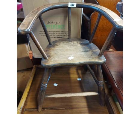 A vintage mixed wood child's bow elbow chair, set on ring turned supports
