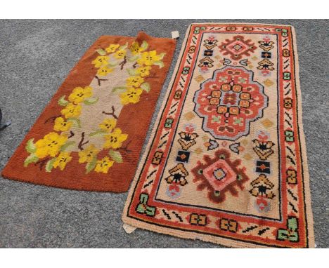 Two vintage tufted wool rugs, the smaller with floral decoration, the larger with central medallion and other motifs on beige