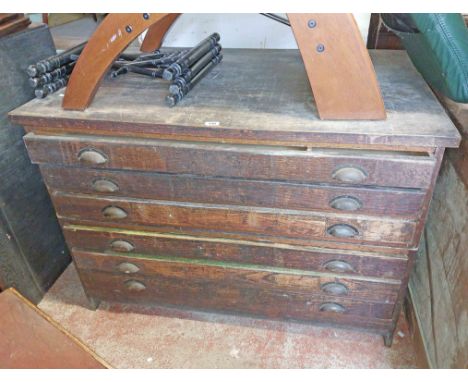 A 1.23m vintage mixed wood two part plan chest with flight of six long drawers, each with brass cup handles