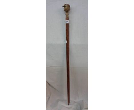 A modern wooden walking stick with compass to handle