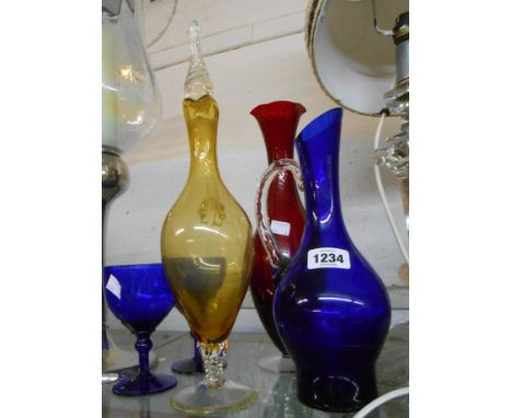 A small quantity of coloured glassware comprising a pair of Bristol Blue wine glasses, a similar carafe, an amber glass clare