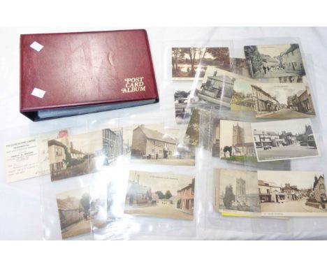 A red ring bound album containing part contents of early 20th Century Kingsteignton interest postcards, mainly named street v