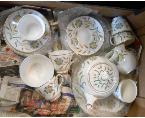 A box containing a quantity of Wedgwood bone china tableware decorated in the Wheatear pattern including teapot, cups and sau