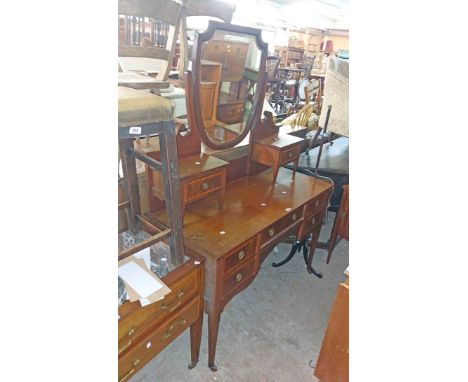 A 1.22m Edwardian mahogany and strung dressing table with shaped bevelled swing mirror and trinket drawers, over a base with 