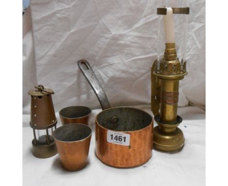 A small Victorian copper saucepan with wrought iron handle and two small copper moulds - sold with a miniature brass miner's 