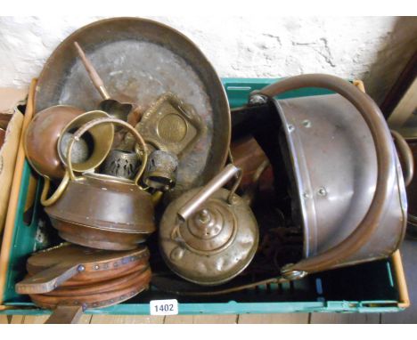 A crate containing a quantity of copper and brass items including helmet form copper coal scuttle, Eastern chased brass inkst