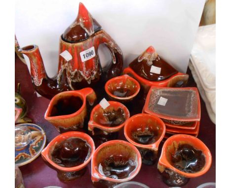 A vintage Vallauris Pottery coffee set comprising coffee pot, milk jug, sucrier, six cups and saucers, decorated with an oran