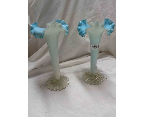 A pair of 19th Century coloured glass vases of trumpet form with light blue, opaque white and clear casing and a frilled wavy