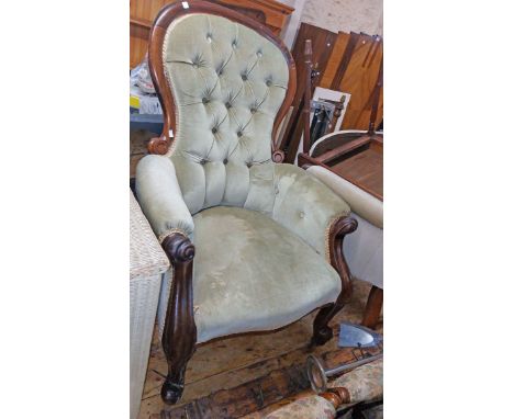 A pair of late Victorian spoon back drawing room armchairs with button back green velour upholstery, set on cabriole front le