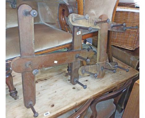 Two similar vintage stained wood wall mounted coat racks, both with turned pegs