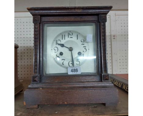 An early 20th Century oak cased mantel clock with eight day gong striking movement