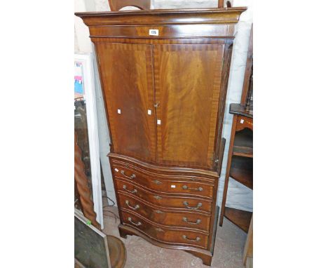 A 71cm reproduction mahogany two part drinks cabinet with part fitted interior and slide, single drawer and a faux drawer fro