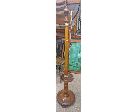 A 20th Century mahogany standard lamp with decorated pillar and circular base