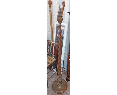 A vintage oak standard lamp with barley twist pillar and circular base - sold with another