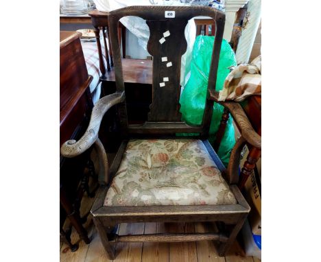 A Georgian oak framed Chippendale style elbow chair with shaped splat back and upholstered drop-in seat, set on moulded front