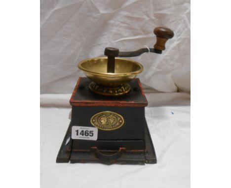 A late 19th Century T. &amp; C. Clark Patent coffee grinder with cast iron body, pull-out drawer and brass funnel