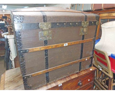 An 81cm early 20th Century dome-top travelling trunk with wood binding and canvas weather coating - internal tray missing