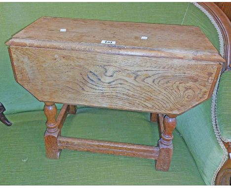 A 59cm early 20th Century light oak drop-leaf tea table with canted corners, set on turned supports