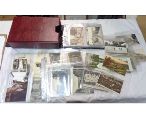 A box sleeved red ring bound album containing a collection of early 20th Century and other Bishopsteignton interest postcards