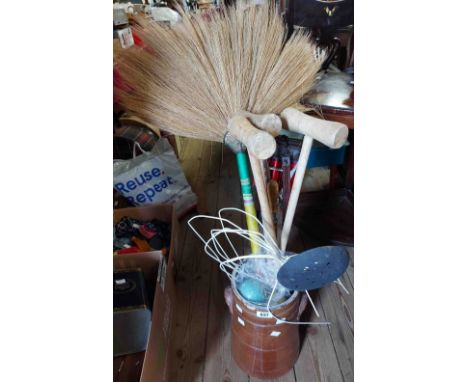 A lidded stoneware pot containing various items including a part crochet set, shooting stick, an old brush, etc.