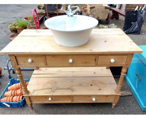 A pine washstand fitted with a modern ceramic sink and mixer tap