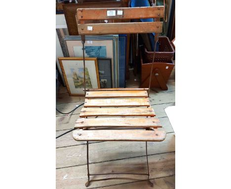 A vintage French style folding bistro chair with slatted back and seat