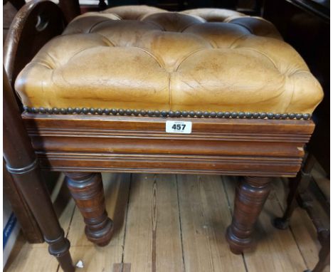 An Edwardian walnut framed adjustable piano stool with patent H. Brooks &amp; Co. screw action and button back leather uphols