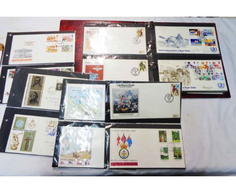A red ring bound album containing a collection of 1970's and 80's FDCs