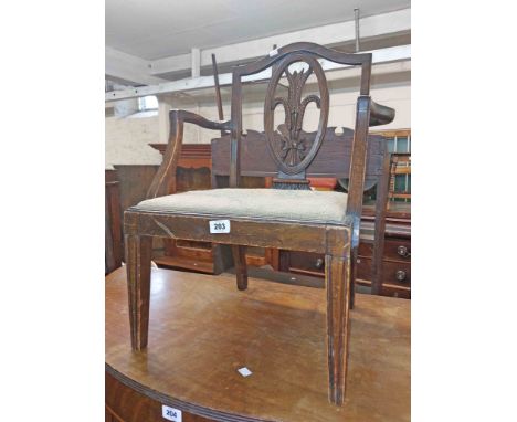 A 1920's mahogany framed Chippendale style child's elbow chair with wheatsheaf and bow pattern splat back, upholstered drop-i