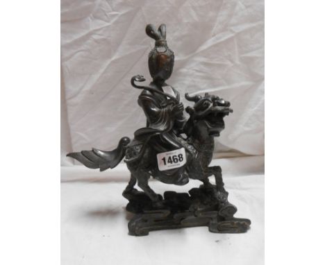 A 20th Century Chinese bronze figure, depicting a deity riding a mythical steed