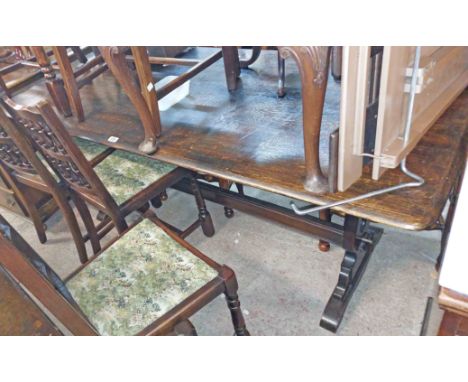 A 1.8m vintage stained oak refectory style dining table, set on pierced standard ends with pegged stretcher - sold with a set