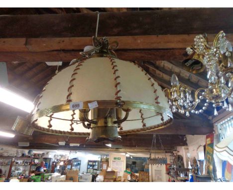 A large vintage brass fitted hanging lamp with animal hide shade