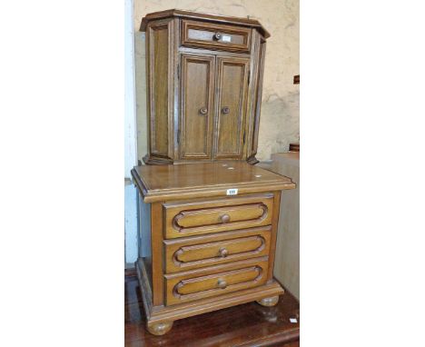 A 66cm vintage oak cabinet with canted corners, single frieze drawer and double cupboard under - sold with a three drawer bes