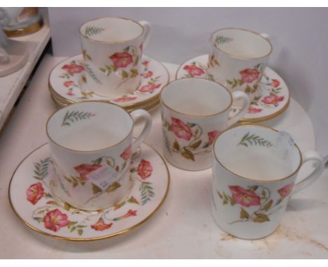 An Abbeydale bone china part coffee set comprising five coffee cans and six saucers, with transfer printed floral decoration