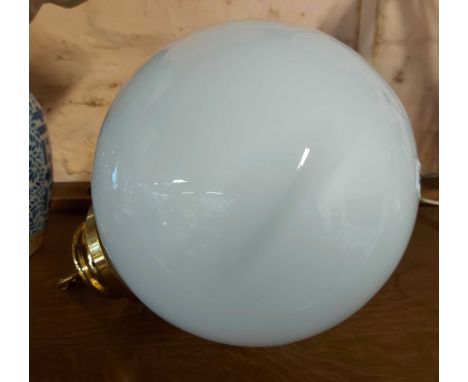 A large opaque glass globe form hanging light with brass fittings