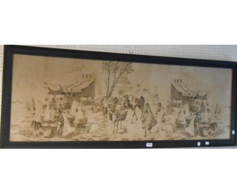 A framed tapestry panel, depicting a market street scene with camels, fruit sellers, etc.