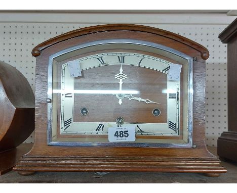 A vintage walnut cased mantel clock with eight day chiming movement