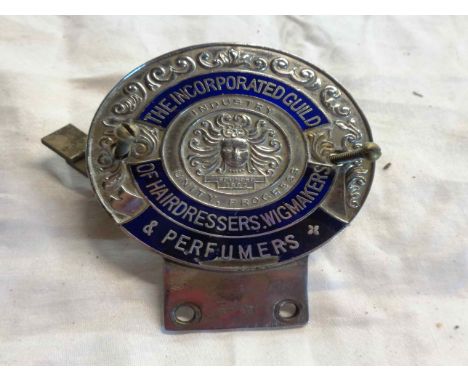 A blue enamel car badge for The Incorporated Guild of Hairdressers, Wigmakers &amp; Perfumers