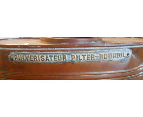 A vintage copper backpack sprayer