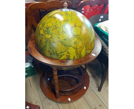 A modern globe form lift-top drinks cabinet with all over printed astrological decoration