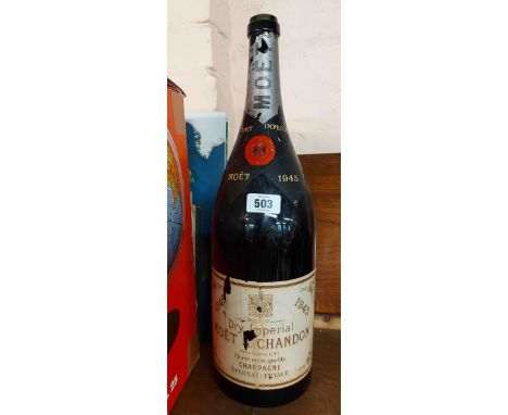 A large vintage Champagne bottle drilled for use as lamp base