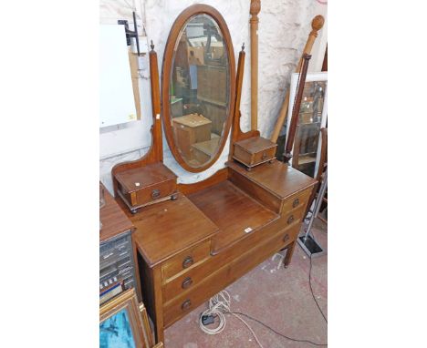 A 1.14m Edwardian mahogany and strung dressing table with bevelled oval mirror and flanking trinket drawers over a base with 