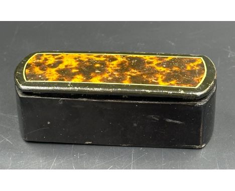 A snuff box with tortoiseshell style lid